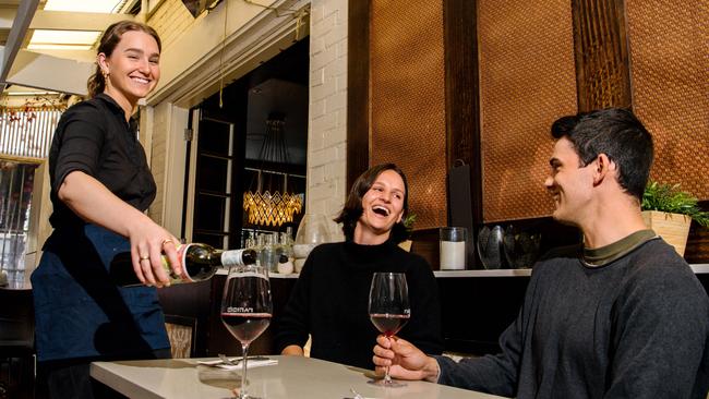 Hannah Morgan serving wine to Harriet Hewitson and Henry Shaw at Parisi’s in Hyde Park. Picture: Morgan Sette