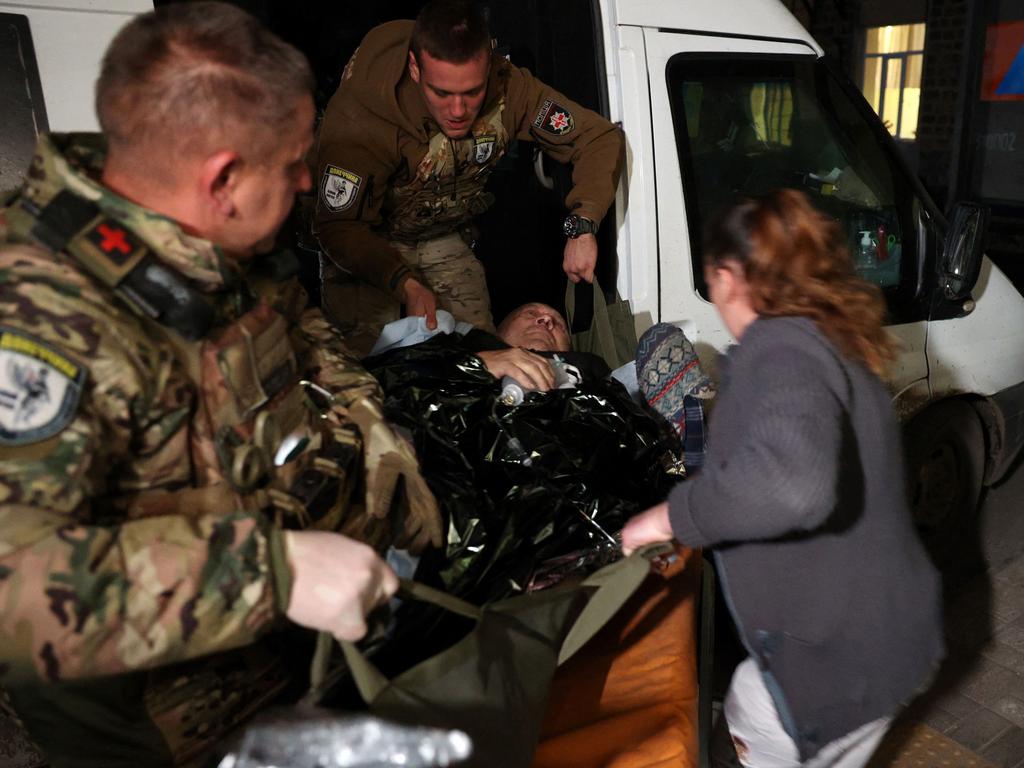 A man, wounded in Avdiivka, is evacuated by policemen on a stretcher from an emergency car at a hospital in Myrnohrad, Donetsk. Picture: AFP