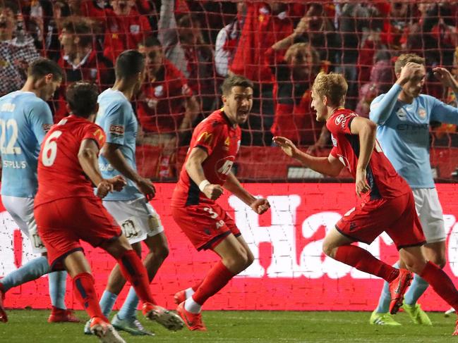 ADELAIDE, AUSTRALIA - MAY 05: Ben Halloran of United celebrates after scoring the winning goal as City players look dejected during the A-League Elimination Final match between Adelaide United and Melbourne City at Coopers Stadium on May 05, 2019 in Adelaide, Australia. (Photo by Scott Barbour/Getty Images)