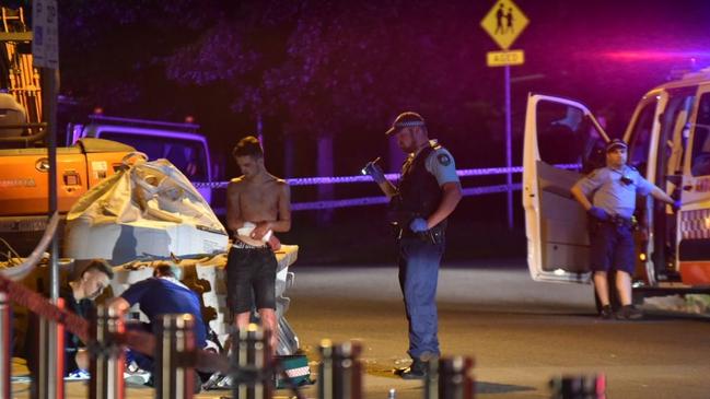 Paramedics attend to two of the victims outside Kipling's Garage Bar at Turramurra. Picture: Dean Asher