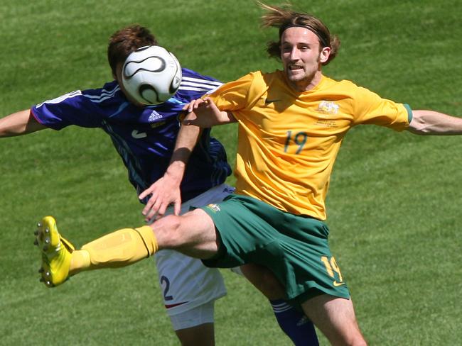 Australian forward Josh Kennedy vies with Japanese defender Teruyuki Moniwa in their first round Group F World Cup football match at Kaiserslautern's Fritz-Walter Stadium.