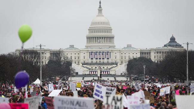 Protesters gather on the National Mall for the Women's March on Washington during the first full day of Donald Trump's presidency, Saturday, Jan. 21, 2017 in Washington. (AP Photo/John Minchillo)