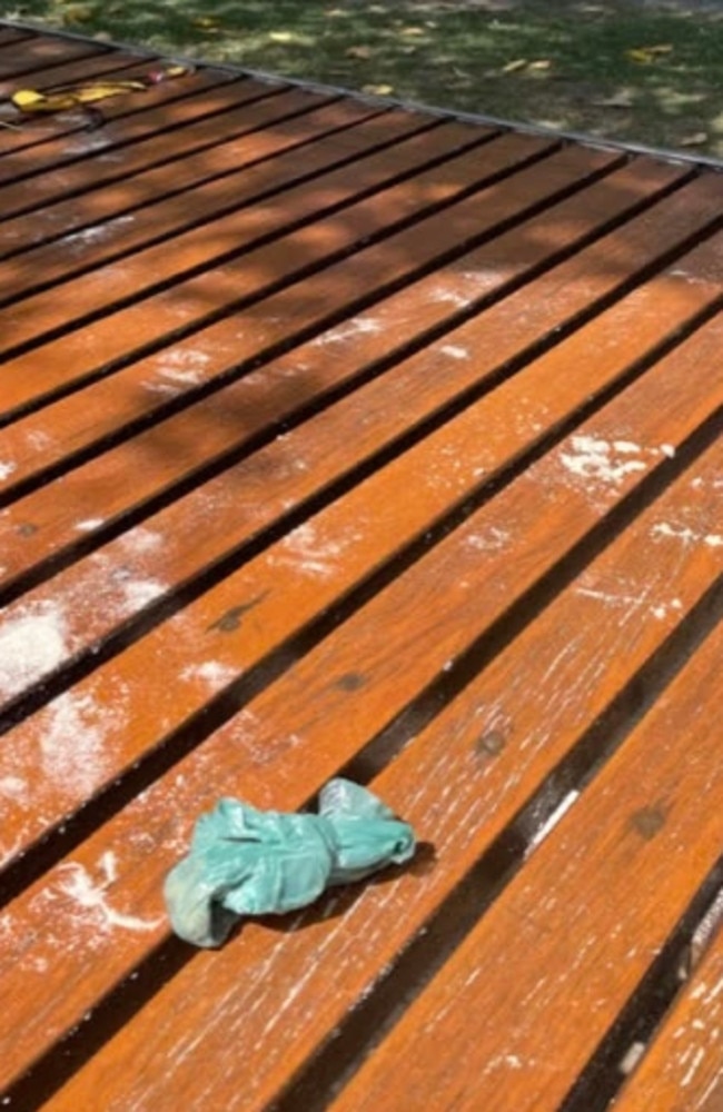 A bag of dog poo and a banana peel left on a wooden seat at beachside showers at Burleigh.