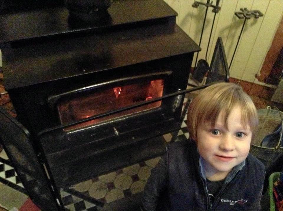 WARM HOME: Isaac Gale standing by the fire (without having helped gather the wood to burn). Picture: Contributed