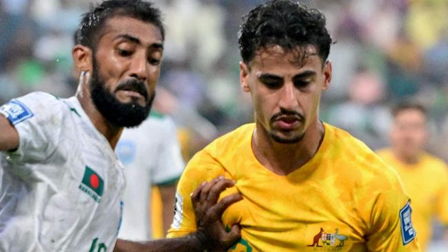 Australia's Daniel Arzani (R) fights for the ball with Bangladesh's Isa Faysal during the 2026 FIFA World Cup Asian qualification football match between Bangladesh and Australia at the Bashundhara Kings Arena in Dhaka on June 6, 2024. (Photo by MUNIR UZ ZAMAN / AFP)