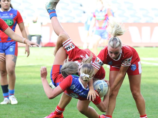 Ella Koster making a big tackle on Newcastle’s Aylah McCulloch. Picture: Warren Gannon Photography