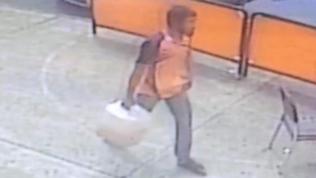 CCTV footage shows Nur Islam walking towards the bank with a fuel container.