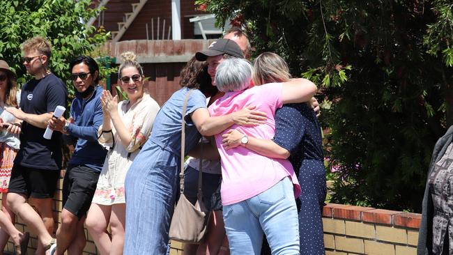 First-time buyers Abby Peach and Sam Huf were embraced in a group hug after purchasing at auction in Newcomb last weekend.