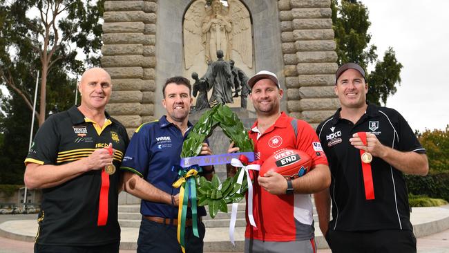 Glenelg coach Brett Hand (left) with Eagles mentor Jade Sheedy, North Adelaide coach Jacob Surjan and Port Adelaide leader Matthew Lokan at the Adelaide National War Memorial ahead of the Anzac Round grand final rematches. Picture: Keryn Stevens