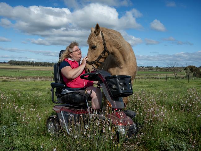 Despite losing her limbs from a rare flesh-eating bacterial infection, Kerrie McDonald, from South Australia, is determined to live life to the fullest, continuing to visit friends and riding her horse, Bella. Picture: Naomi Jellicoe