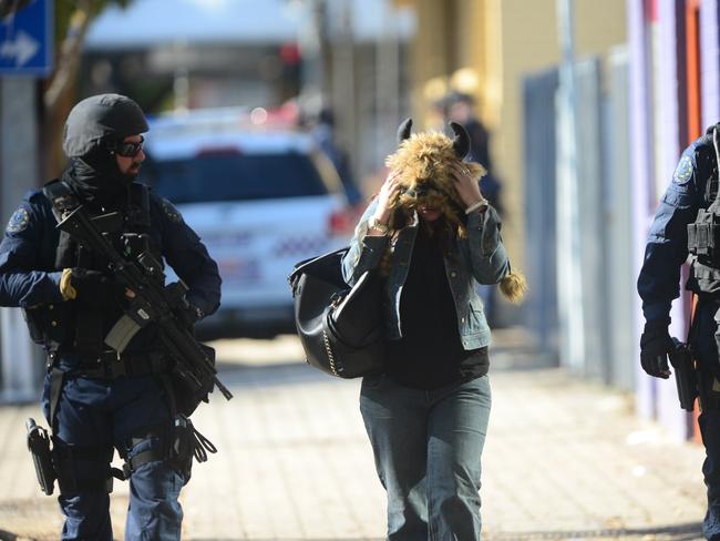 STAR Group officers with one of the women after she left the massage parlour. Picture: Tom Huntley