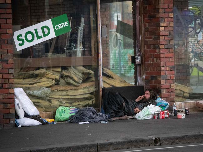 Homeless people are sleeping rough in Melbourne during covid pandemic even though they have been offered hotel rooms in the city. A man lays in Fitzroy Street. Picture: Jason Edwards