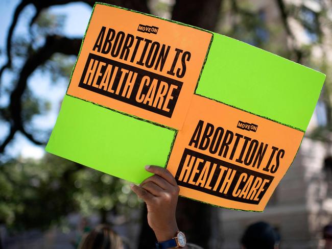 (FILES) In this file photo taken on October 8, 2022 An abortion rights demonstrator holds a sign outside of the Harris County Courthouse during the Women's Wave march in Houston, Texas. - Retail pharmacies in the United States will be permitted to sell abortion pills, health officials said Tuesday, a move that could significantly expand access to the procedure after last year's landmark Supreme Court ruling that overturned federal abortion rights. (Photo by Mark Felix / AFP)