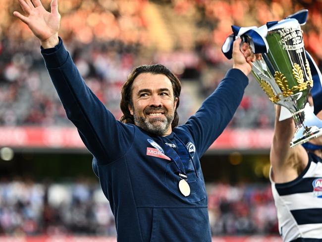 MELBOURNE, AUSTRALIA - SEPTEMBER 24: Chris Scott, Senior Coach of the Cats raises the Premiership Cup during the 2022 Toyota AFL Grand Final match between the Geelong Cats and the Sydney Swans at the Melbourne Cricket Ground on September 24, 2022 in Melbourne, Australia. (Photo by Daniel Carson/AFL Photos via Getty Images)