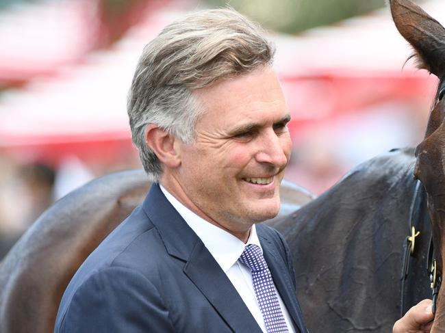 MELBOURNE, AUSTRALIA - FEBRUARY 26: Trainer Tom Dabernig poses with Flying Mascot after winning Race 2, the Catanach's Jewellers Mannerism Stakes,  during Melbourne Racing at Caulfield Racecourse on February 26, 2022 in Melbourne, Australia. (Photo by Vince Caligiuri/Getty Images)