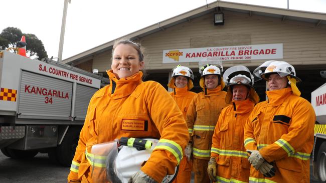 Katelyn Benham, the first senior firefighter of the Kangarilla CFS brigade, with her fellow volunteers. Picture: Russell Millard/AAP