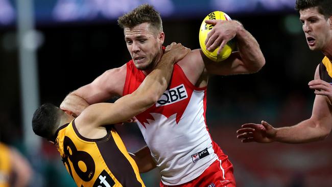 Luke Parker barges through Hawthorn's Paul Puopolo. Picture: Phil Hillyard