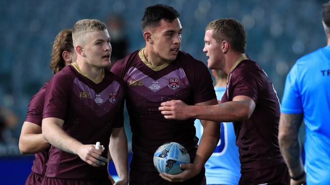 Fa'asuamaleaui is congratulated by teammates after scoring for Queensland under 18s against NSW in 2018. Picture: Adam Head