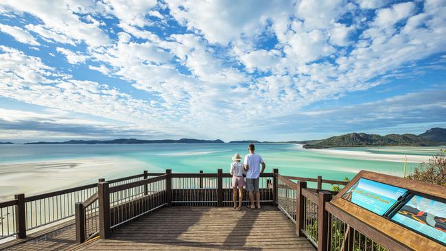 Couple looking out to view Whitsunday Island. Picture: Brooke Miles for Riptide Creative escape