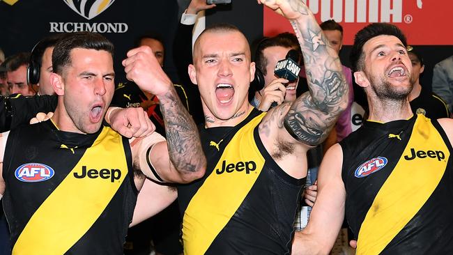 MELBOURNE, AUSTRALIA - SEPTEMBER 20: Jack Graham, Dustin Martin and Trent Cotchin of the Tigers sing the song in the rooms after winning  the AFL Preliminary Final match between the Richmond Tigers and the Geelong Cats at Melbourne Cricket Ground on September 20, 2019 in Melbourne, Australia. (Photo by Quinn Rooney/Getty Images)