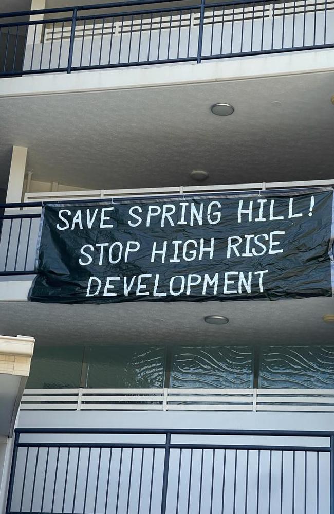 A protest sign on a nearby unit block.