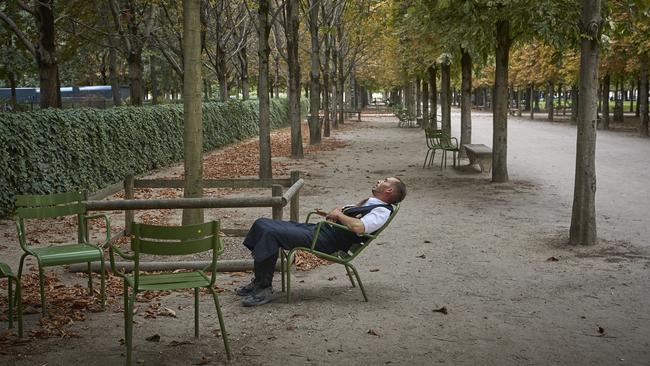 A waiter sleeps in the shade of the Tuileries Garden in Paris over the weekend. Picture: Getty Images