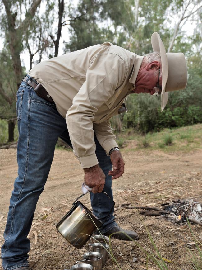 Peter Hughes boils the billy next to the Connors River on Tierawoomba Station.