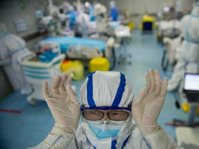 A nurse adjusts his goggles in an intensive care unit treating COVID-19 coronavirus patients at a hospital in Wuhan, in China's central Hubei province.