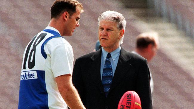 Wayne Carey speaks to North Melbourne club doctor Dr Harry Unglik.