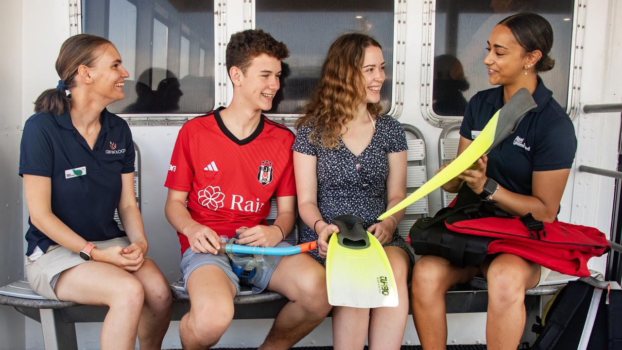 Reef Magic Marine Biologist Zoe Carnahan (left) and cruise attendant Paris Fellows (right) tell UK brother and sister tourists Stanley and Olivier Mather the finer points of snorkelling for their day on the Great Barrier Reef. Picture: Brian Cassey