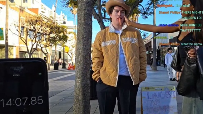 Norme shows visible discomfort as a young woman forces a hot dog into his mouth. Picture: YouTube