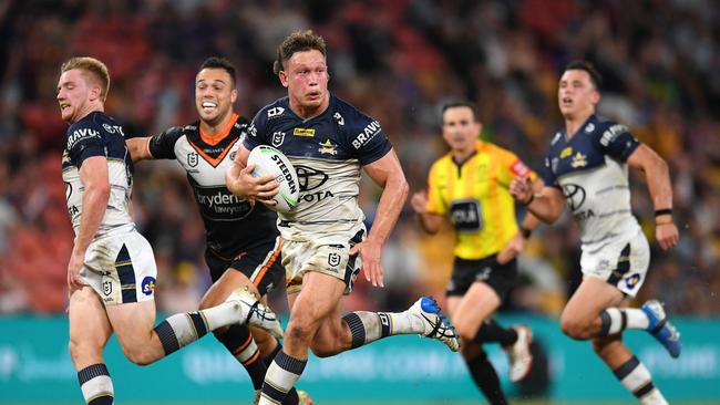 Reuben Cotter makes a break for the Cowboys before scoring a try during their round 10 match against the Wests Tigers. (Photo by Albert Perez/Getty Images)