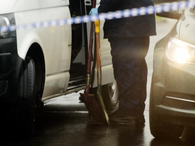 Homicide squad carry shovels during an investigation in which three children were found injured at a home in Broadmedows, Melbourne, Tuesday, July, 5, 2016. The children were hospitalised following an alleged dispute at a home in Broadmeadows after police arrived just after 10pm on Monday, police say, with a man, who is known to the children, being arrested and interviewed. (AAP Image/Tracey Nearmy) NO ARCHIVING