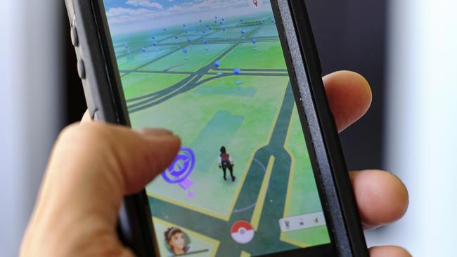 By deploying a Pokébeacon, criminals were able to lure victims into a trap. Picture: Richard Vogel/AP