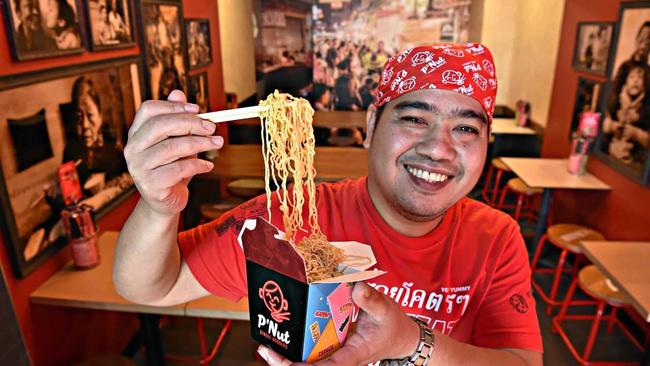 SMILES FOR NOODLES: P'Nut Street Noodles head chef Nut Kunlert with tasty noodles at his restaurant in Kawana Shoppingworld. Picture: Warren Lynam