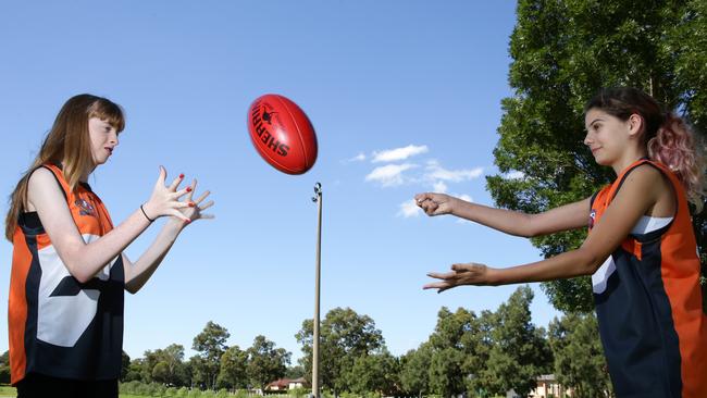 Shelby Draper, 13, Sarah Young, 15, are considering playing in the Youth Girls team in the inaugural U15 Youth Girls AFL competition.