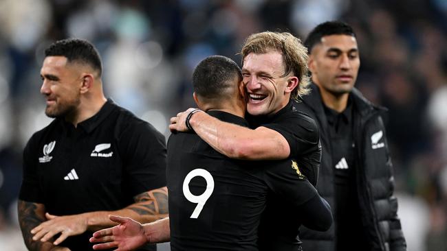 PARIS, FRANCE - OCTOBER 20: Damian McKenzie of New Zealand embraces teammate Aaron Smith following the team's victory during the Rugby World Cup France 2023 semi-final match between Argentina and New Zealand at Stade de France on October 20, 2023 in Paris, France. (Photo by Hannah Peters/Getty Images)