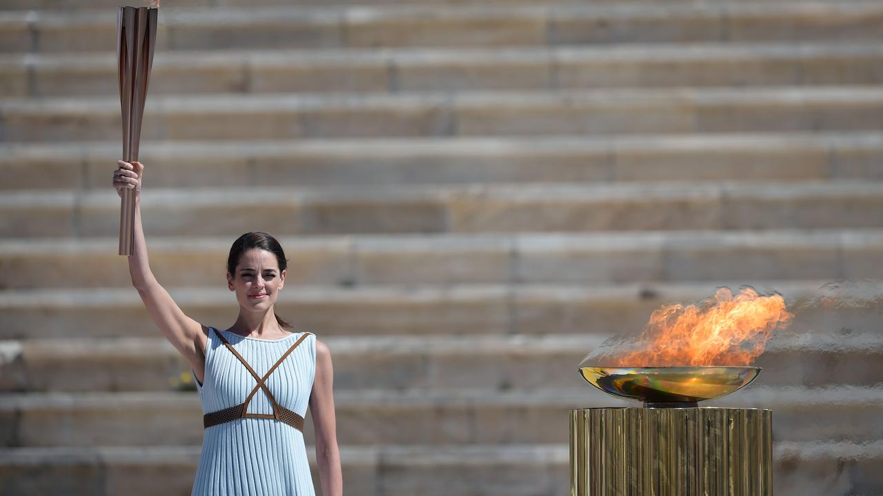 Greek actress Xanthi Georgiou dressed as an ancient Greek high priestess holds the Olympic torch.