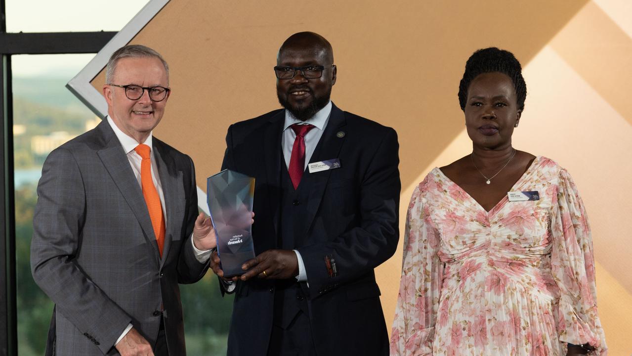 Mr Mabil’s mum Agot Day Atem and uncle Michael Matiop accepted the award from Anthony Albanese on his behalf. Picture: NCA NewsWire / Gary Ramage