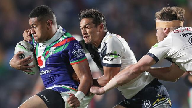 Martin attempts to tackle David Fusitu’a of the Warriors, when the pain in his head first started. Picture: AAP Image/David Rowland