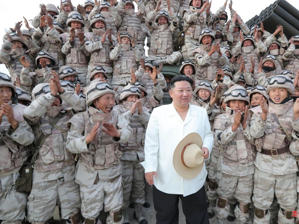 North Korea's leader Kim Jong-un (C) posing as the North Korean People's Army frontline long-range artillery division and air force squadron conduct a fire attack training exercise, at an undisclosed location. Picture: AFP