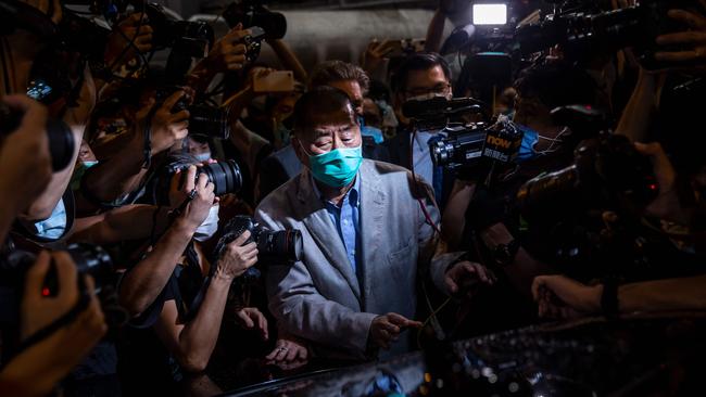 Hong Kong pro-democracy media mogul Jimmy Lai pushes past media after being released on bail from the Mong Kok police station in August, Picture: AFP