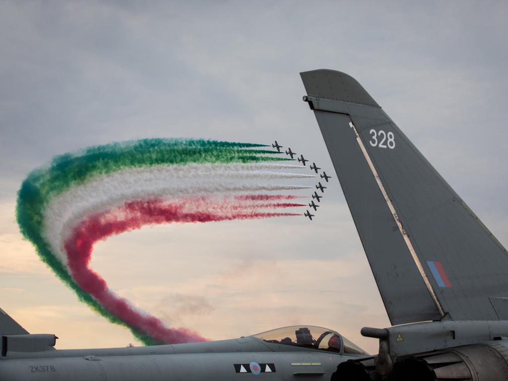 The Frecce Tricolori, Italian Air Force aerobatic display team fly above Royal Air Force Eurofighter Typhoons that are being displayed at the Royal International Air Tattoo at RAF Fairford on July 13, 2018 in Gloucestershire, England. Today is the opening day of the three-day event, which this year coincides with the centenary year of the Royal Air Force, attracting thousands of aviation enthusiasts. (Photo by Matt Cardy/Getty Images)