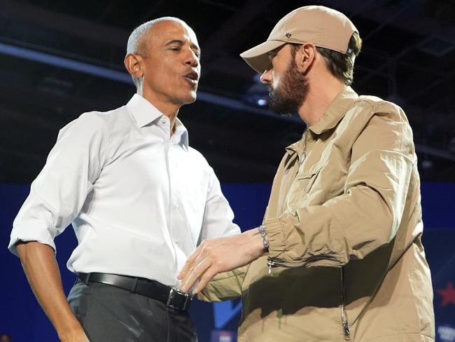 Rapper Eminem, right, greets former President Barack Obama, left, on stage at a campaign rally supporting Democratic presidential nominee Vice President Kamala Harris, Tuesday, Oct. 22, 2024, in Detroit. (AP Photo/Paul Sancya)