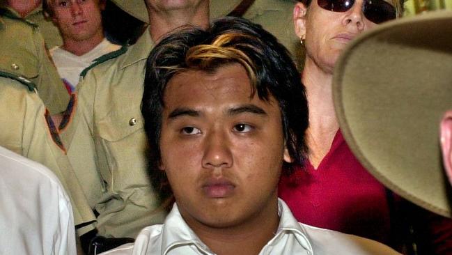 Phu Ngoc Trinh, who along with Ben William McLean, was convicted of murdering two women in 2004, is escorted by police through Darwin Airport. Picture: Michael Marschall