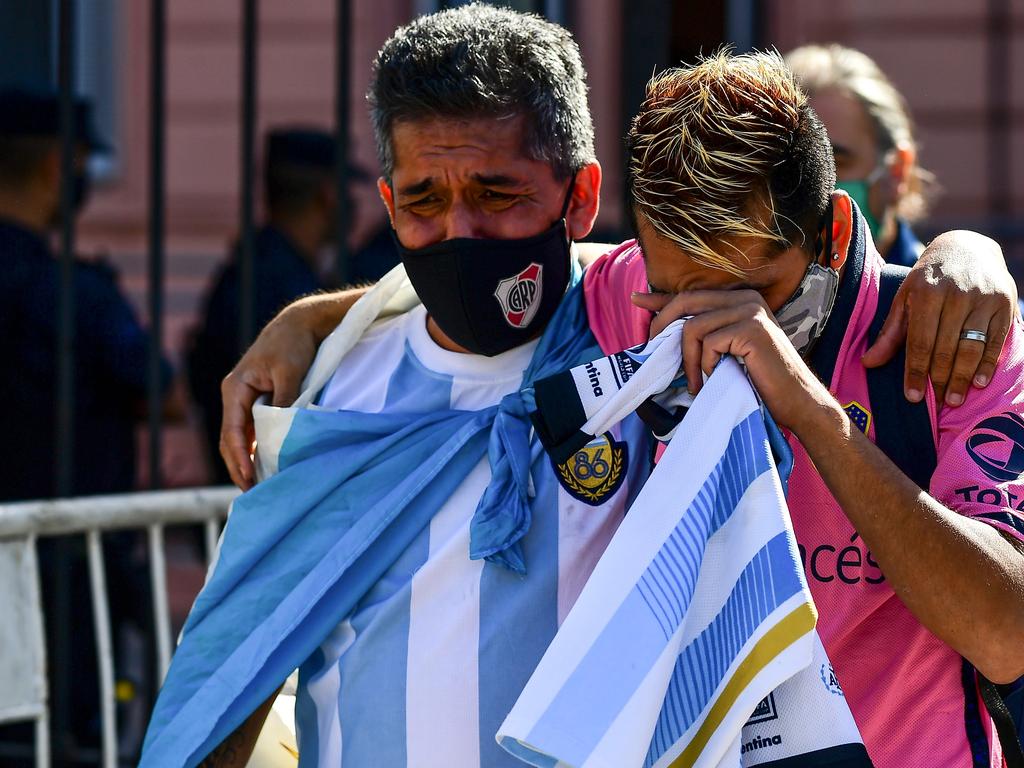 Fans mourn outside the Casa Rosada government house as they wait to pay tribute to Argentinian late football legend Diego Maradona. Picture: AFP