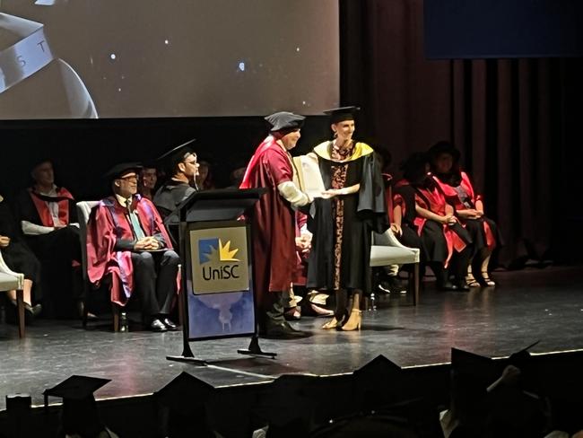 Graduates from the University of the Sunshine Coast's Fraser Coast campus celebrating at the Brolga Theatre.