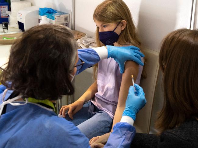 A young girl is vaccinated in Austria. Picture: AFP