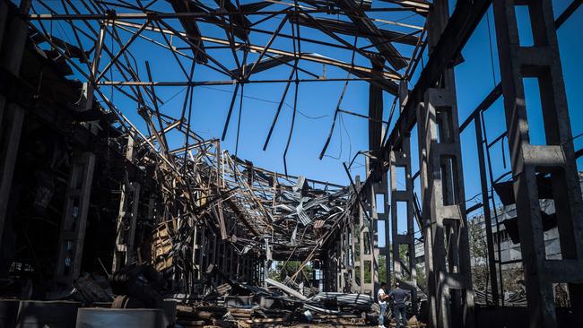 Locals examine the remains of an industrial building damaged after a Russian missile strike in Odesa. Picture: AFP