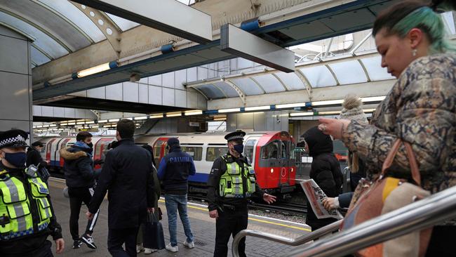 In London, Transport Police officers check passengers are wearing face coverings on a Piccadilly Line tube train at Hammersmith as part of the response to the new Omicron strain of Covid-19. Picture: Adrian Dennis/AFP